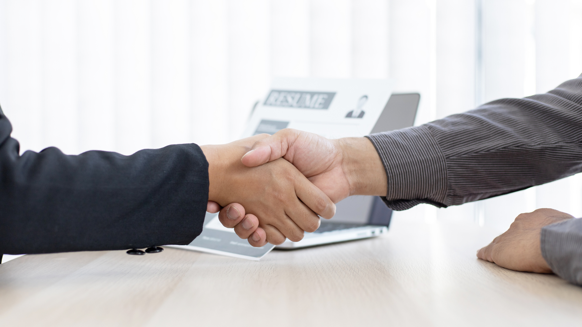 An image of a CPA candidate shaking hands with an employer in Toronto after accepting a new Career in Accounting.