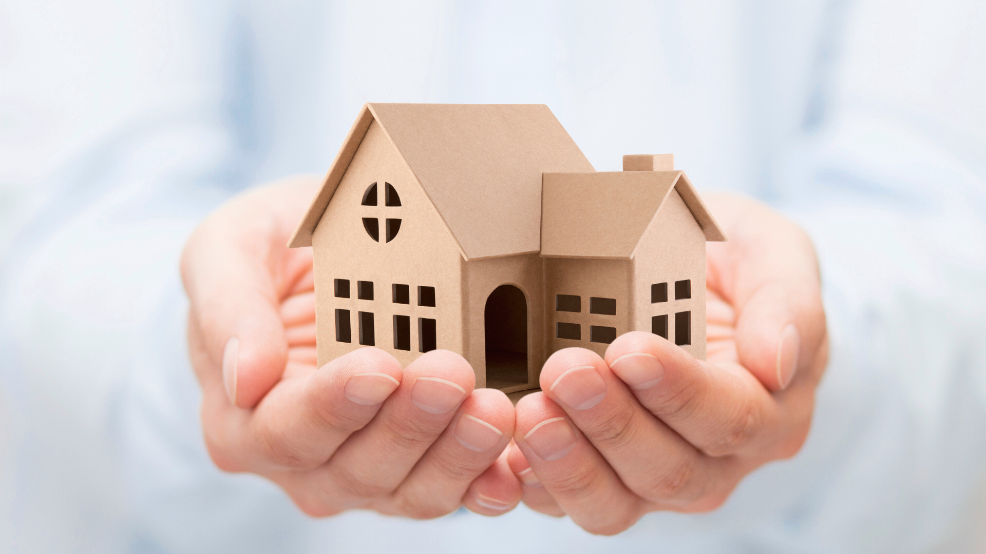 An image of a small business owner in North York holding a cardboard cutout of an estate in their hands.