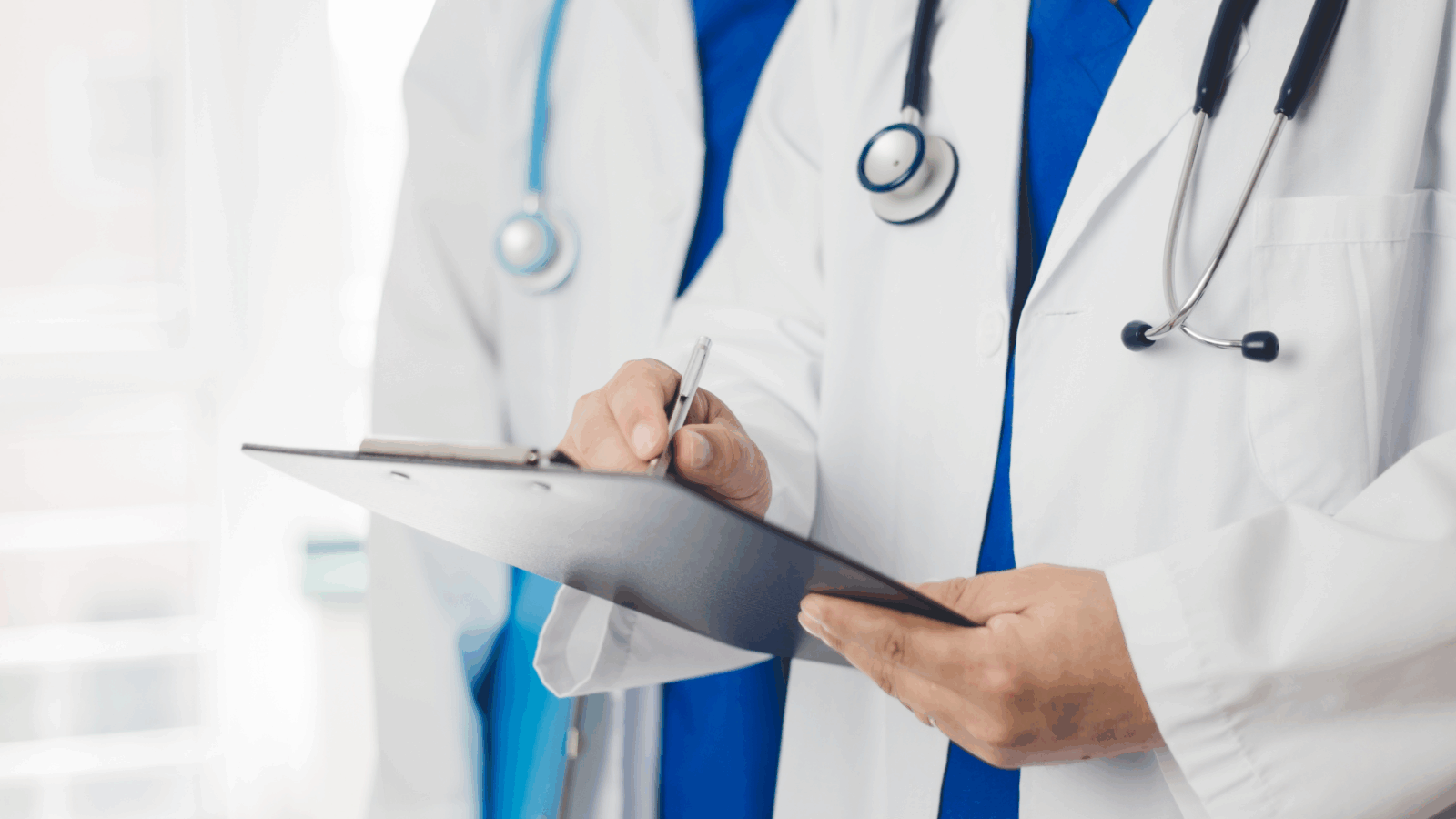 An image of two doctors chatting about a client in their North York office.
