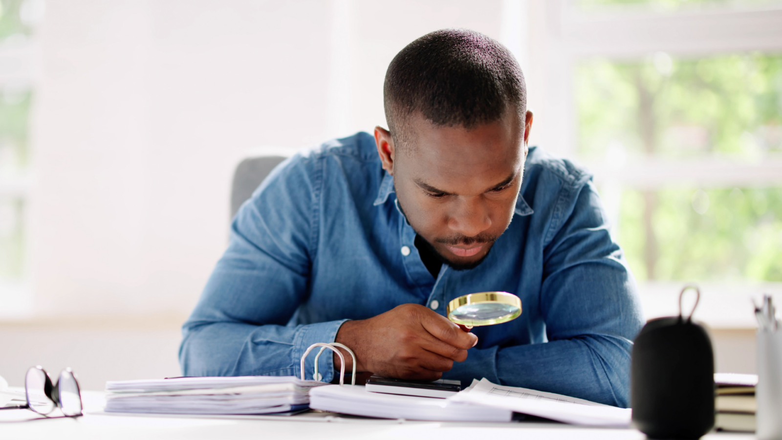 An image of a small business owner who is reviewing his tax information after he has received CRA Audit notice